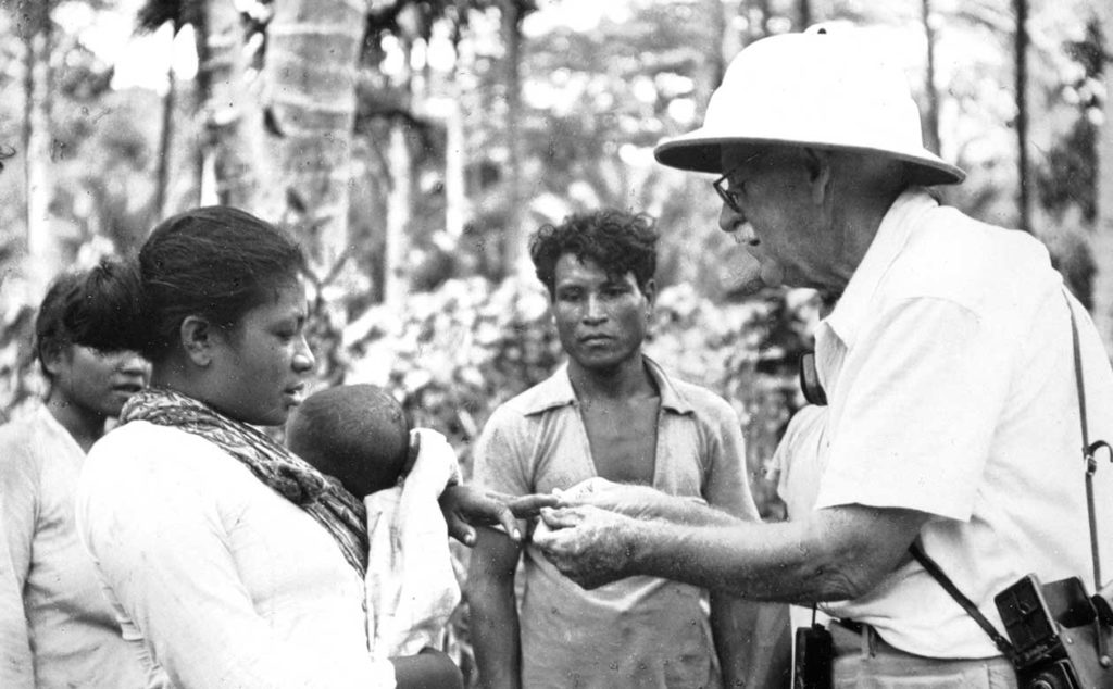 Dr. David Fairchild with children in Indonesia. Fairchild was a 19th century plant hunter and adventurer tasked with increasing the biodiversity of American agriculture. He introduced thousands of plants to the US. 